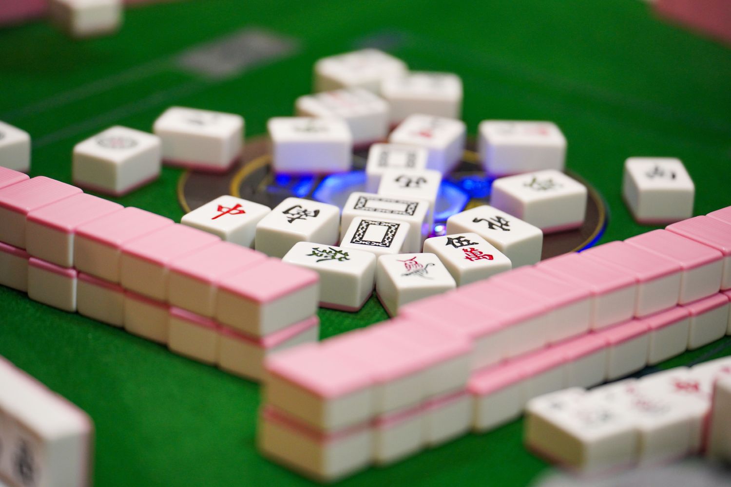 Mahjong tiles arranged on a table, ready for play